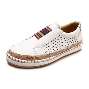 White hollow-out slip-on loafer with colorful striped tongue and cork-textured sole