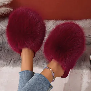 Detail view showing the fluffy burgundy faux fur texture of warm winter house slippers