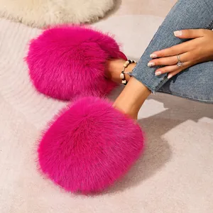 Close-up detail of hot pink fluffy faux fur slippers with soft warm texture for home