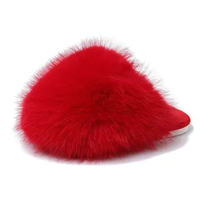 Detail view of vibrant red fluffy faux fur slipper with soft sole and warm winter design