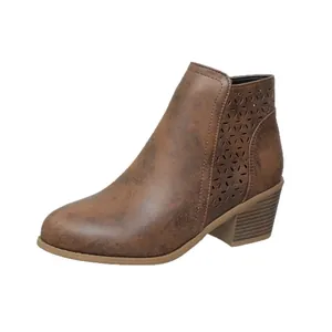 Side view detail of brown block heel ankle boots featuring laser-cut floral patterns