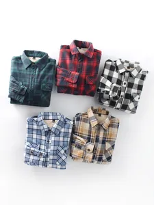 Detailed close-up view of multiple colored flannel plaid shirts with warm fleece lining insulation.