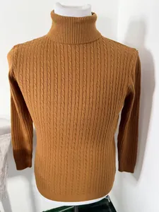 Detailed view of men's camel brown turtleneck sweater with cable-knit texture.