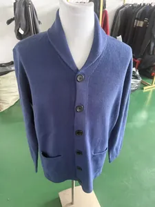 Detailed view of a blue men's knit cardigan with shawl collar and buttons on a mannequin