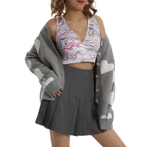 Detailed view of women's heart pattern cardigan with crop top and pleated skirt