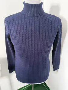 Detailed view of men's navy blue turtleneck sweater featuring a classic cable-knit pattern