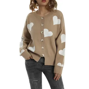 Close-up view of a stylish camel knit cardigan with white heart patterns and buttons