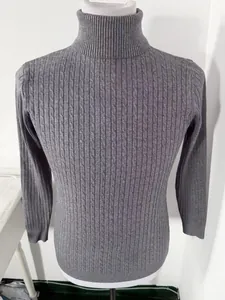 Detailed view of a grey cable-knit turtleneck sweater for men with twist pattern.