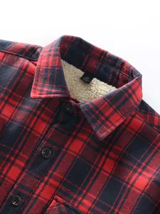 Detailed view of red plaid flannel shirt collar with warm cream sherpa fleece lining