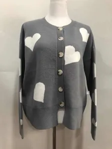 Elegant grey knit cardigan featuring large white heart jacquard and drop shoulders