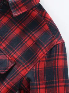 Close-up of red and navy blue checkered flannel shirt fabric texture and stitching