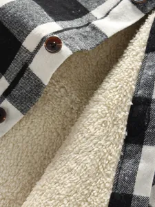 Close-up detail of thick white sherpa fleece lining on a black and white plaid shirt