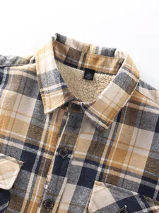 Detailed close-up of men's plaid shirt featuring warm sherpa fleece lining and buttons