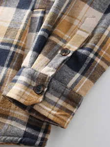 Close-up of a men's plaid flannel shirt sleeve with button cuffs and soft texture