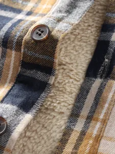 Macro view of soft warm fleece lining and buttons on a blue and yellow plaid shirt