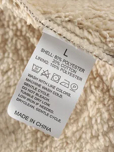 Close-up showing material care label on a men's fleece-lined warm shirt jacket