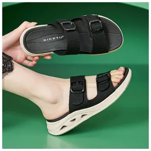 Detail view of breathable black platform sandals with hollow beige soles and buckles