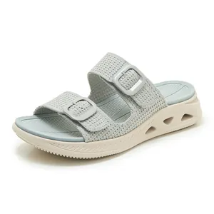 Detail of breathable women's platform slides with hollow sole and double buckles
