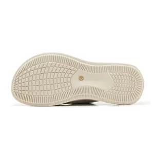 Macro detail view of the anti-slip textured sole on a beige platform sport slipper
