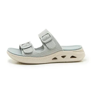 Detail view of breathable mesh upper and hollowed-out thick sole of women's sports slides.
