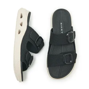 Detail view of women's black slides with breathable hollow thick sole and buckle straps.