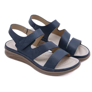 Detailed view of navy blue triple-strap wedge sandals with comfortable padded insole.