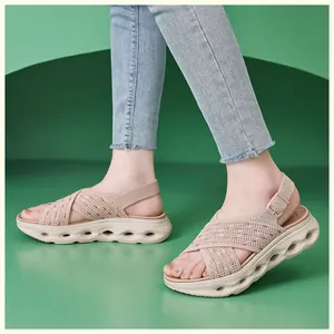 Detailed side view of a woman wearing breathable beige fly knit platform sandals with hollow soles