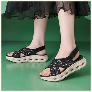 Detailed view of comfortable black knit platform sandals with hollow out thick soles.