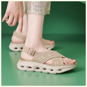 Close-up of beige fly-knit platform sandals with cross-over straps on model