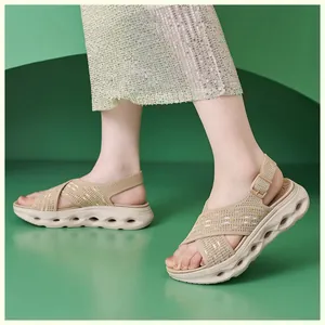 Detail of lightweight beige flyknit platform sandals on feet with buckle strap.