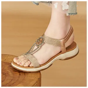 Detail of women's Bohemian rhinestone sandals with champagne gold straps and soft sole