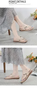 Detail view of beige women's wedge flip-flop sandals with metallic strap accents.