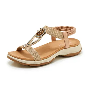 Detailed view of bohemian rhinestone sandal featuring braided straps and soft cushioned sole