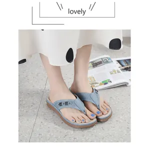 Close-up of blue wedge flip-flop sandals with laser-cut detailing and comfort sole