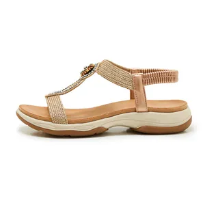 Profile view of Bohemian sandals with rhinestone details and elastic strap.