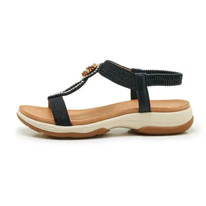 Side view of black Bohemian sandals with rhinestones and elastic back strap.