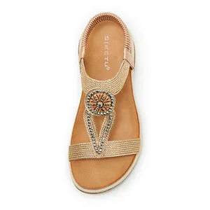 Detailed overhead view of bohemian gold sandal with sparkling rhinestone ornament