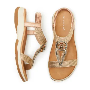 Bohemian style women's flat sandals with champagne gold woven straps and rhinestone detail