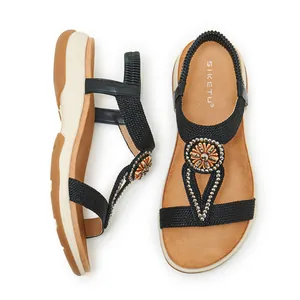 Detail view of Bohemian women's sandals with intricate rhinestone floral decorations