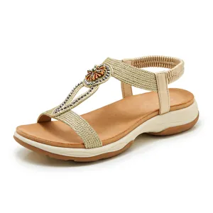 Elegant bohemian women's sandals with gold woven straps and sparkling rhinestones