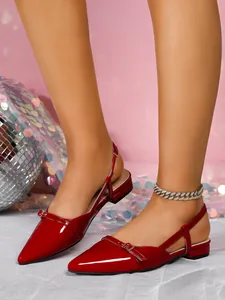 Detail view of red patent leather pointed-toe slingback flat sandals for women