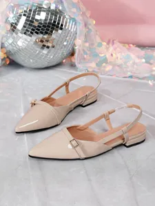 Elegant nude pointed-toe slingback flats with buckle detail on a shimmering background