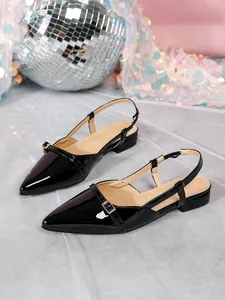 Elegant black patent leather pointed-toe slingback shoes featuring a stylish gold buckle detail