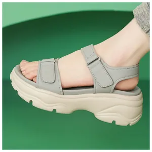 Detail view of stylish grey platform sandals with beige chunky soles and adjustable velcro straps