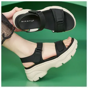 Close-up of black platform sandals for women with adjustable velcro straps and chunky soles