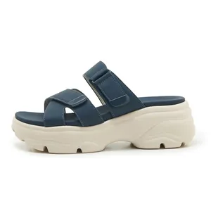 Seitenansicht dunkelblauer Plateau-Sandalen mit cremefarbener klobiger Sohle und Klettverschluss.