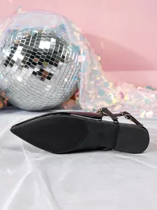 Close-up detail of black patent leather pointed toe slingback shoe sole with anti-slip texture.
