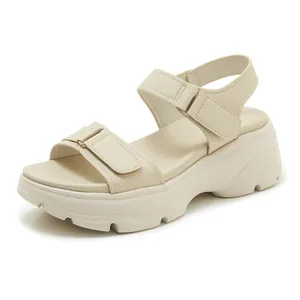 Side view of cream platform sandal featuring adjustable beige hook-and-loop straps.