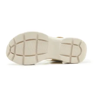 Close-up of beige thick platform sandal sole with non-slip wave pattern tread texture