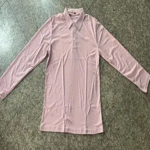 Close-up detail of a soft pink long-sleeved polo shirt for men featuring a buttoned collar